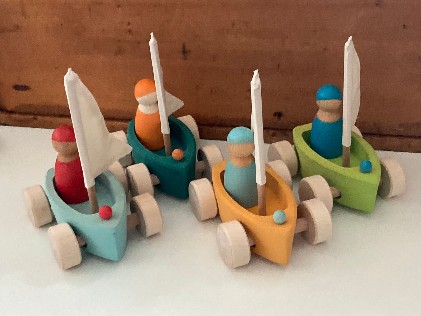 Wooden Toy - Grimm's SAILBOATS, on wheels, each with SKIPPER! (set of 4)
