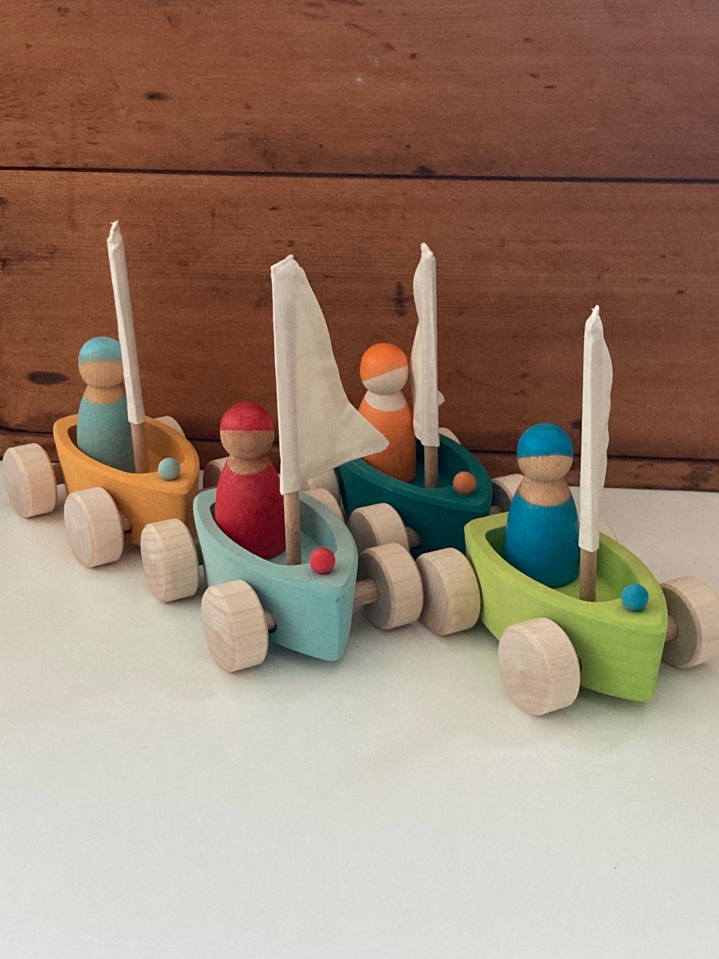 Wooden Toy - Grimm's SAILBOATS, on wheels, each with SKIPPER! (set of 4)