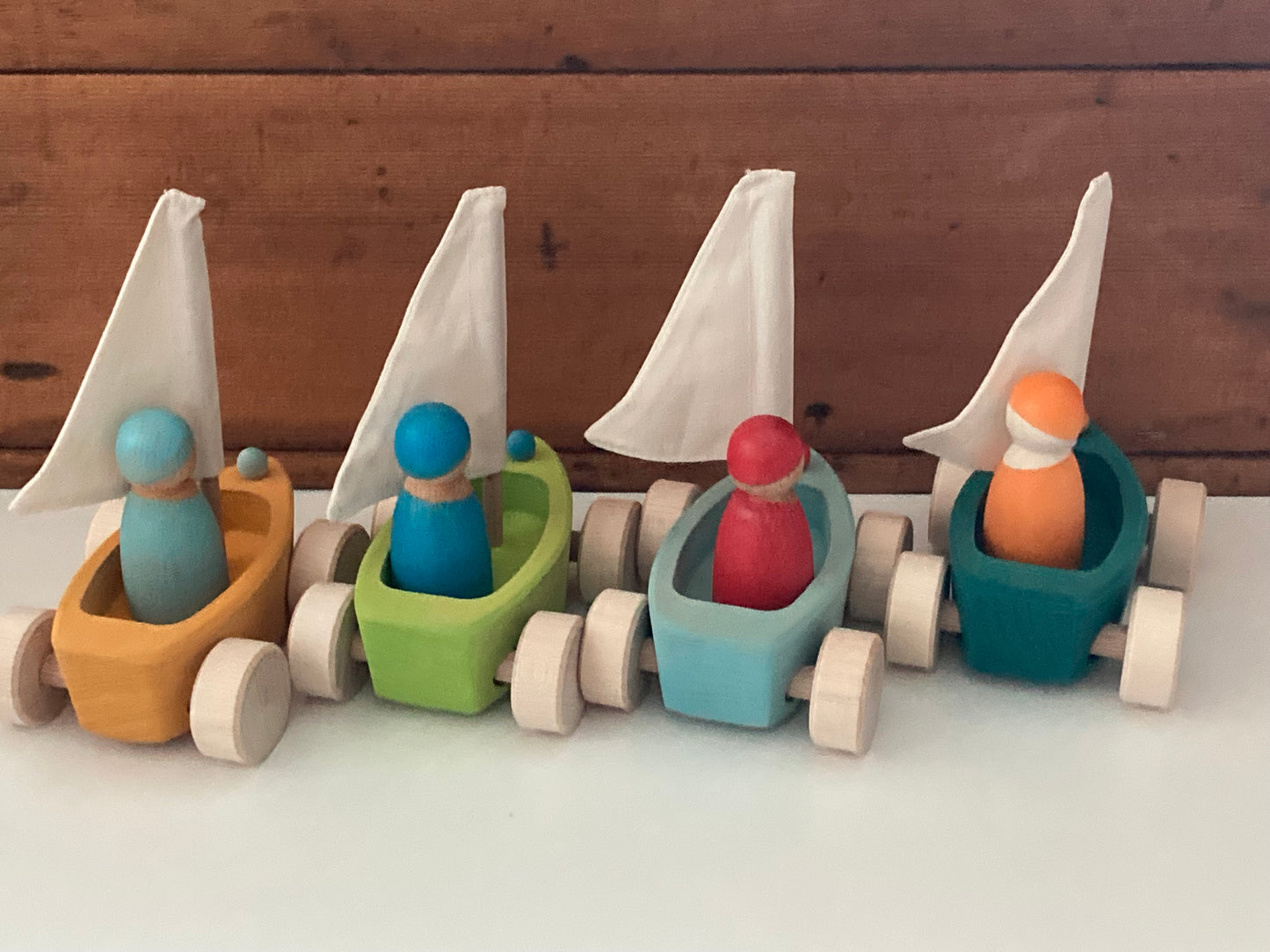 Wooden Toy - Grimm's SAILBOATS, on wheels, each with SKIPPER! (set of 4)