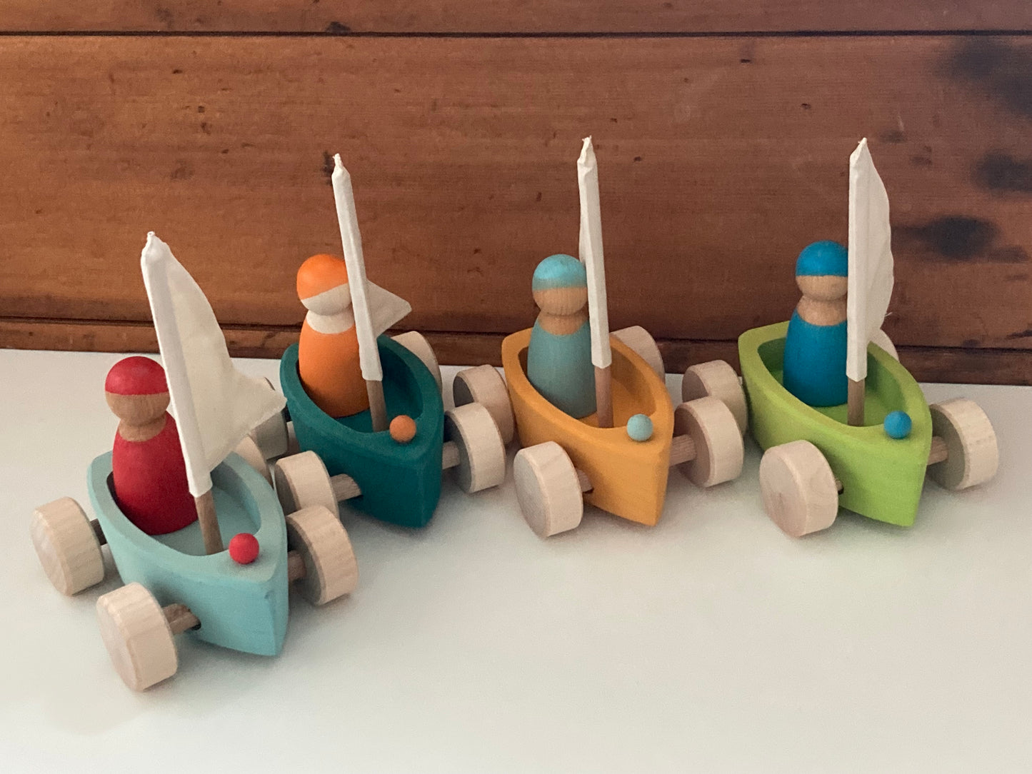 Wooden Toy - Grimm's SAILBOATS, on wheels, each with SKIPPER! (set of 4)